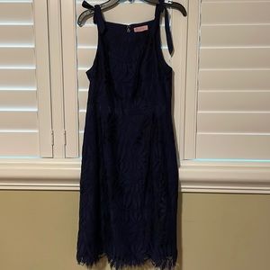 Navy blue Lilly Pulitzer Dress bows on strap and lace over slip. Satin waistband